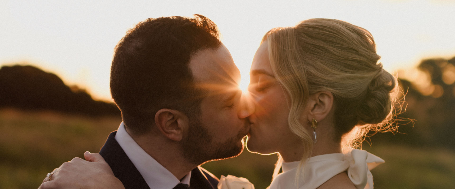 Wedding couple kissing at sunset - married by Chiquita Mitchell